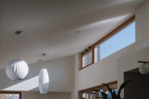 MARIAN HAWTHORN - High clerestory windows and modern pendant lighting in a bright Australian home by Coys Constructions.