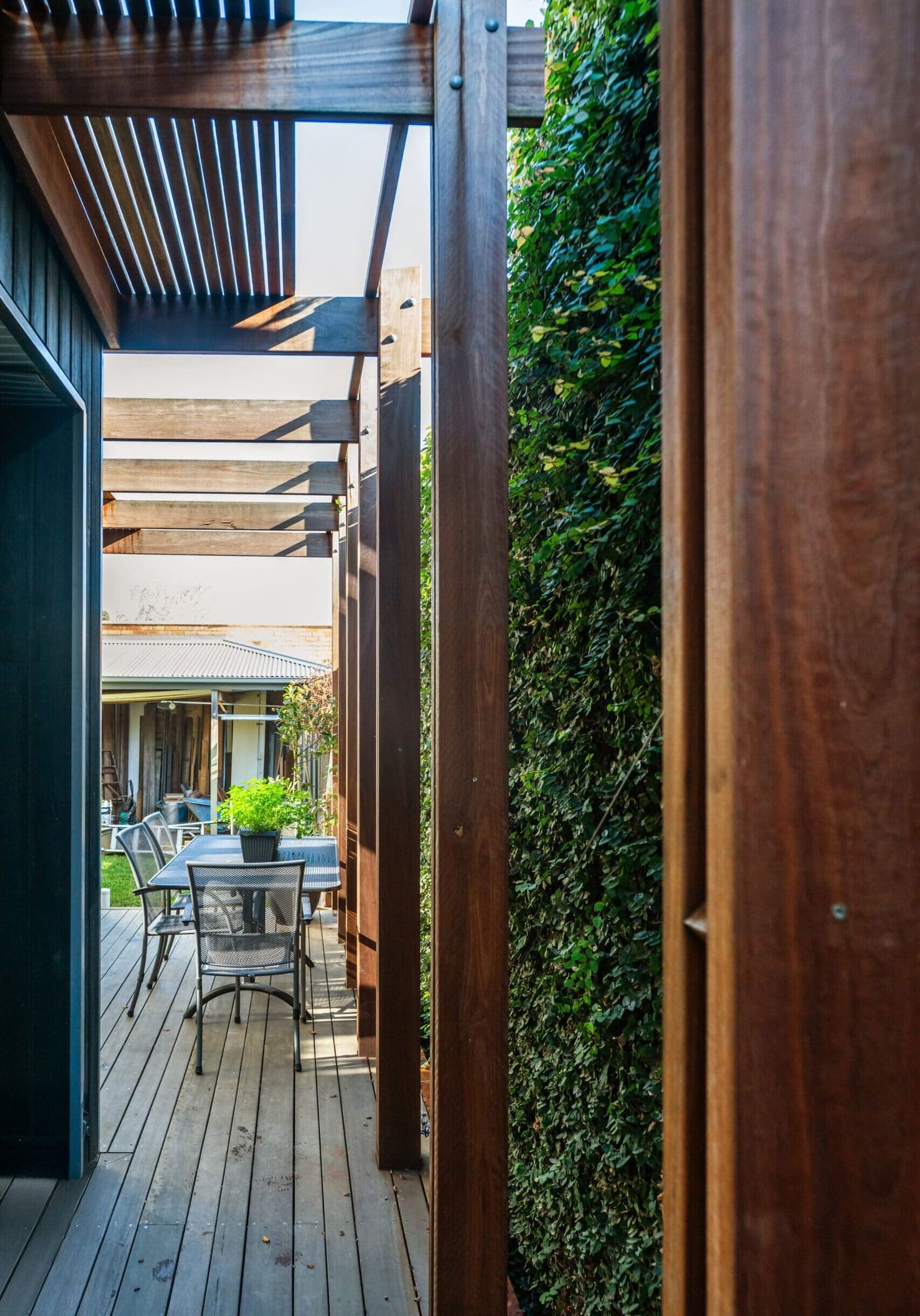 MARIAN HAWTHORN Custom timber pergola and outdoor dining area with lush greenery and hardwood decking, designed by Coy's Constructions to enhance modern Australian backyard living. MARIAN HAWTHORN Custom timber pergola and outdoor dining area with lush greenery and hardwood decking, designed by Coy's Constructions to enhance modern Australian backyard living.